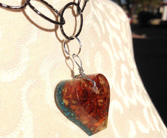 Crushed red peppers in resin pendant.