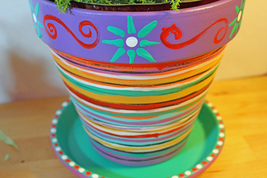 Here is a tutorial for painted flower pots by CraftyChica.com.