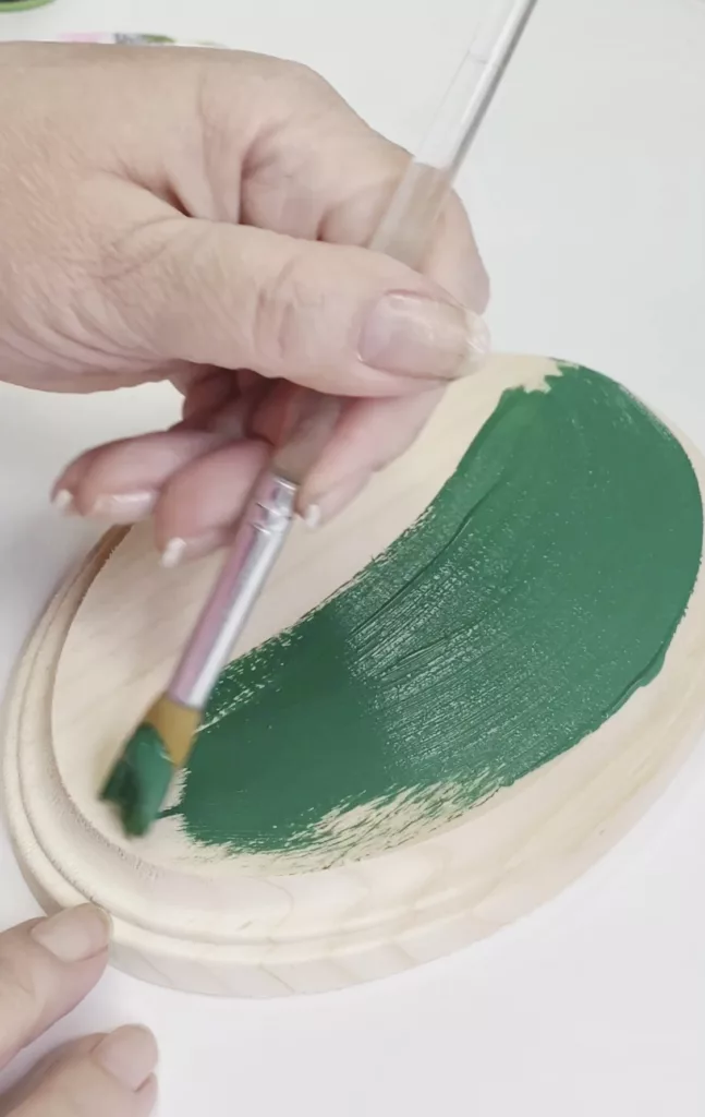Paint carving: Adding a layer of paint to wood plaque.