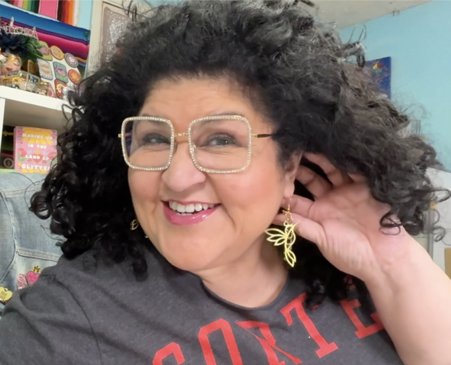 Kathy wearing hummingbird earrings she made with the xTool M2.